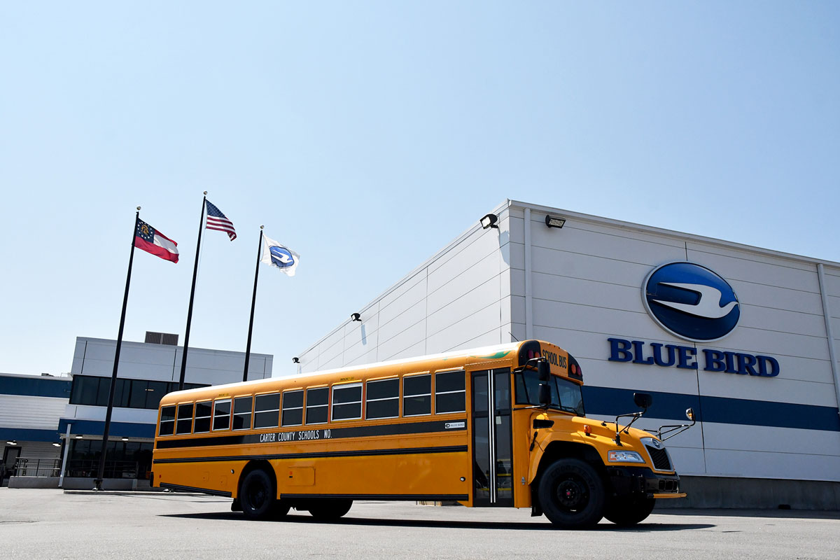 Blue Bird Next Generation Vision EV Bus in front of Fort Valley Blue Bird Plant
