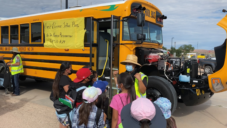 Navajo youth entering Blue Bird electric school bus